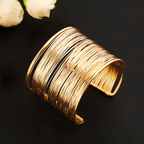 Gold wire cuff bracelet on black background, elegant jewelry accessory, modern fashion statement piece, women's wristwear, chic design.