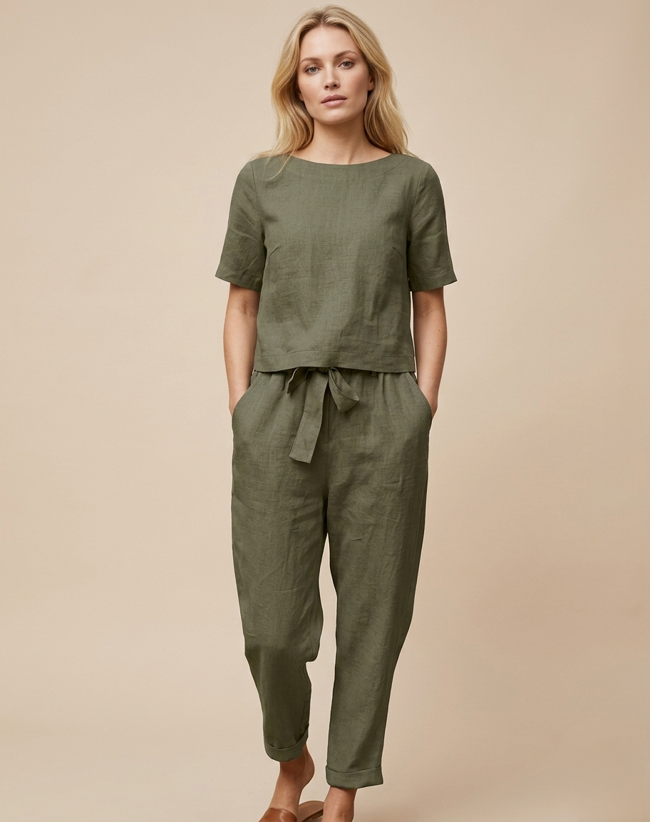 Woman wearing a green outfit with a belt on a beige background