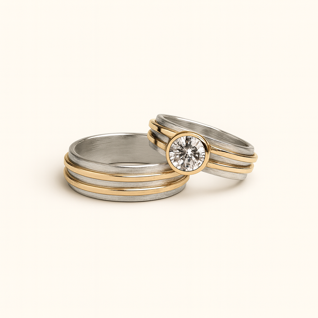 Two gold and silver rings with a diamond on a beige background