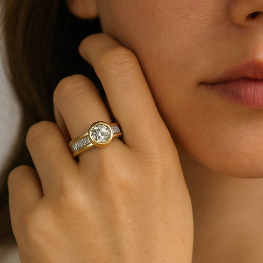 Close-up of a hand wearing a gold ring with a diamond, touching the face.