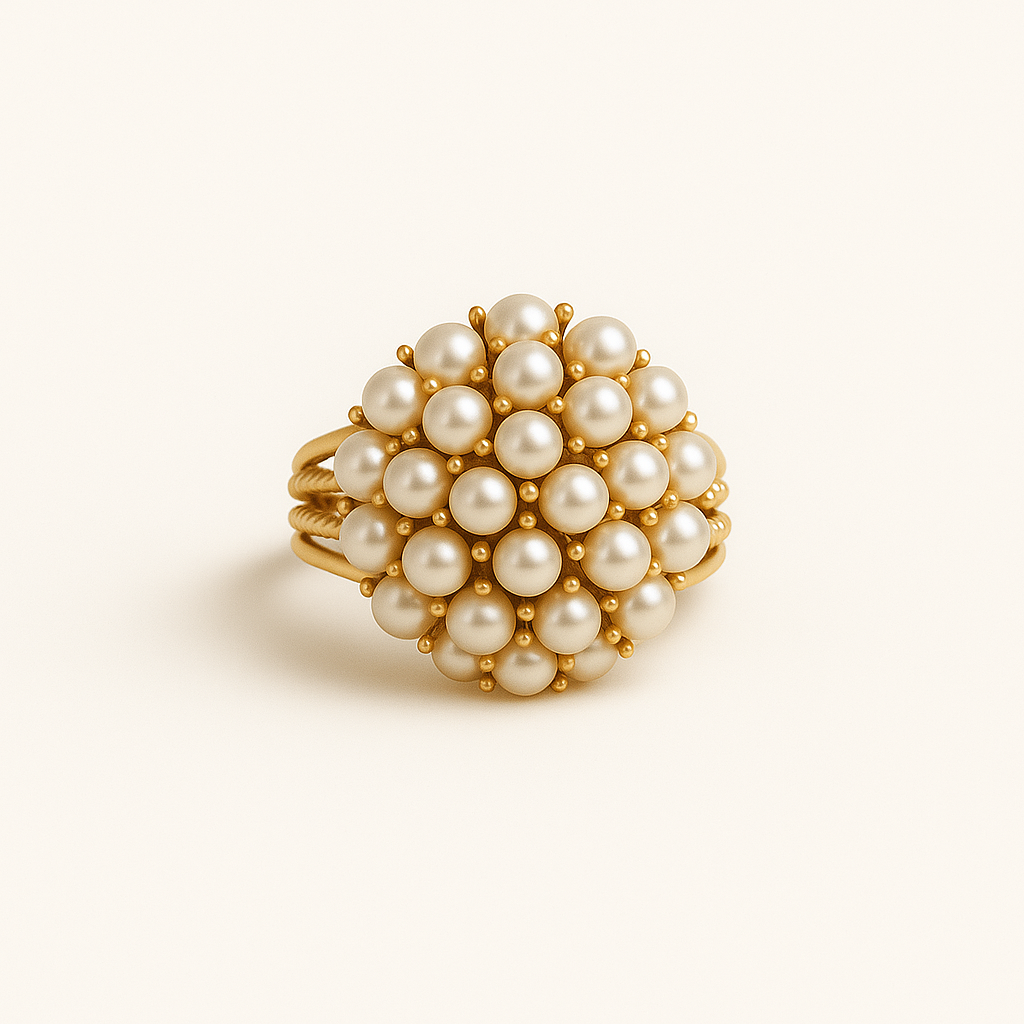 Gold ring with pearl beads on a beige background