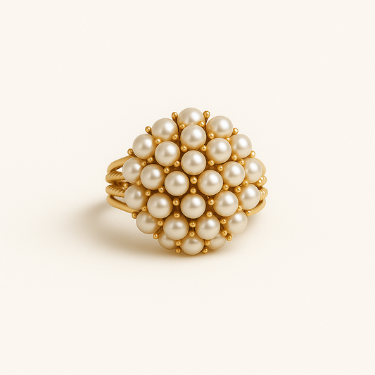 Gold ring with pearl beads on a beige background