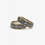 Two intricately designed rings on a white background