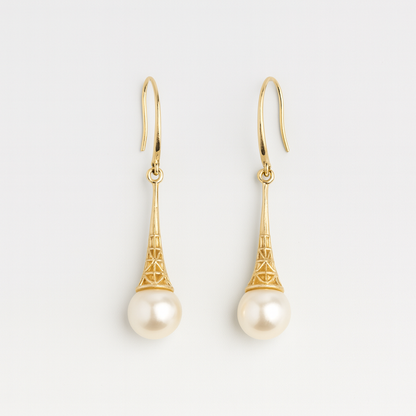 Gold earrings with pearl drops on a light gray background