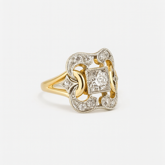 Gold ring with diamond accents on a light gray background