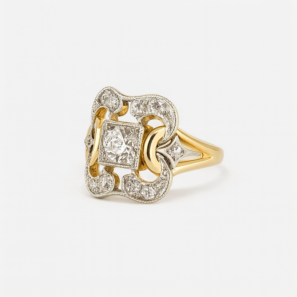 Gold and silver ring with diamond accents on a white background