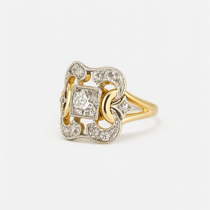 Gold and silver ring with diamond accents on a white background
