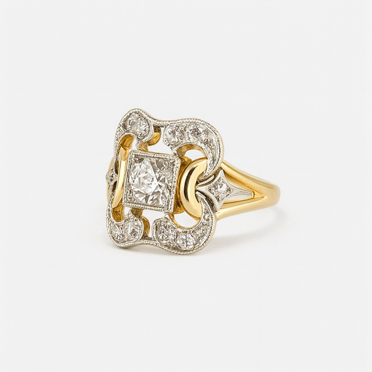 Gold and silver ring with diamond accents on a white background