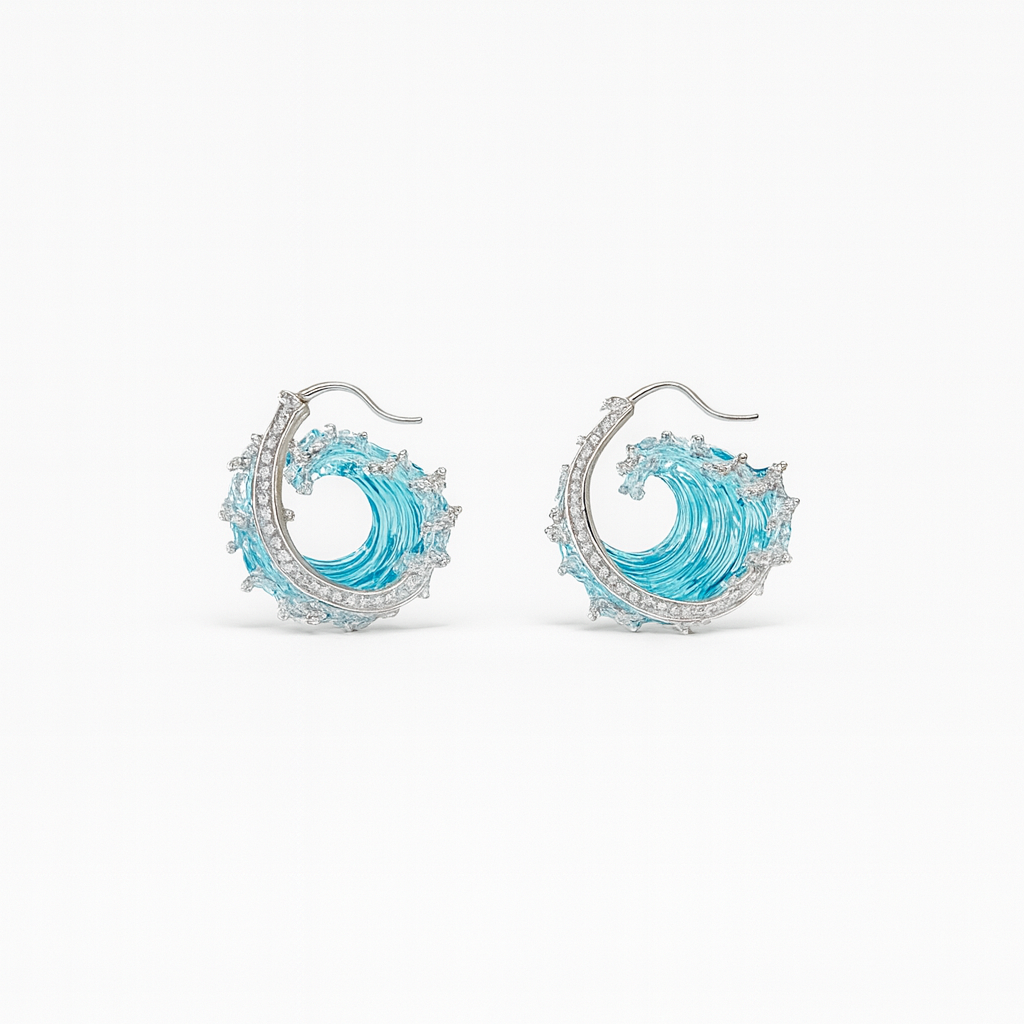 Elegant ocean wave earrings with blue enamel and silver detailing, featuring sparkling gemstones. Perfect for beach-themed fashion and jewelry lovers.