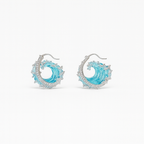Elegant ocean wave earrings with blue enamel and silver detailing, featuring sparkling gemstones. Perfect for beach-themed fashion and jewelry lovers.