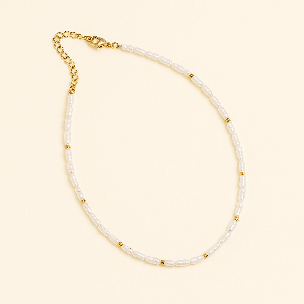 Elegant pearl necklace with gold accents and adjustable chain clasp on a beige background, perfect for fashion and jewelry enthusiasts.