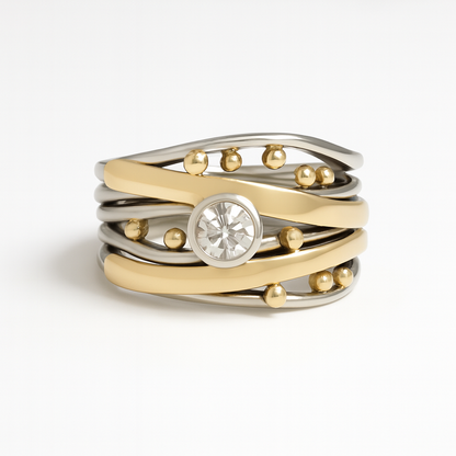 Stack of gold and silver rings with a central gemstone on a white background