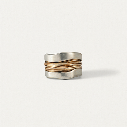 Wide silver ring with wavy design and gold accents, minimalist jewelry, modern fashion accessory, elegant unisex ring, unique statement piece.