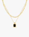 Gold layered chain necklace with a black rectangular pendant, featuring a sleek design. Perfect for fashion-forward jewelry enthusiasts.