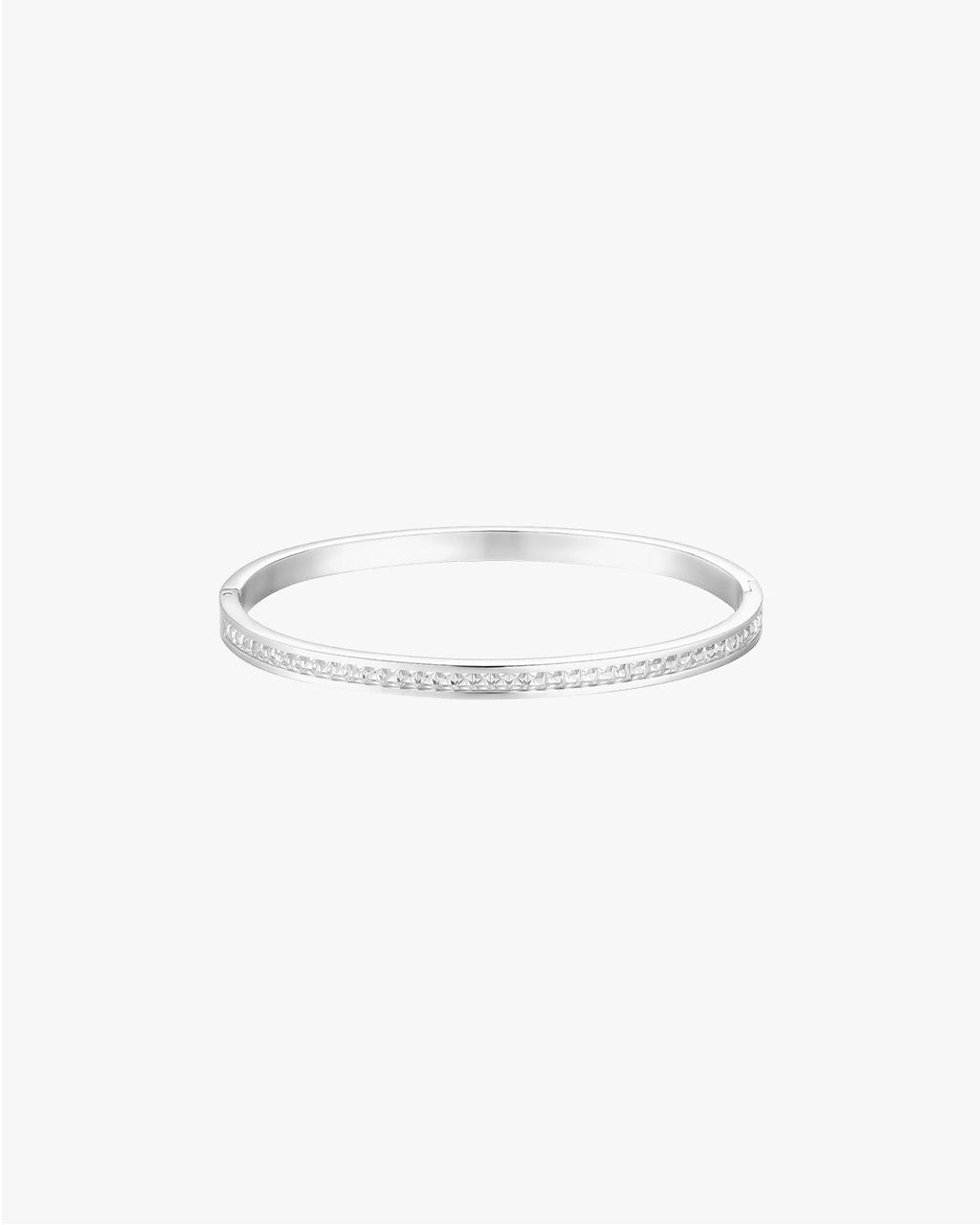 Silver bangle bracelet with a sleek design and subtle diamond accents, perfect for elegant fashion accessories and jewelry collections.