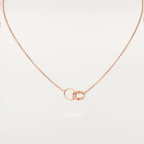 Rose gold necklace with interlocking rings pendant, minimalist jewelry design, elegant chain, perfect for everyday wear or special occasions.