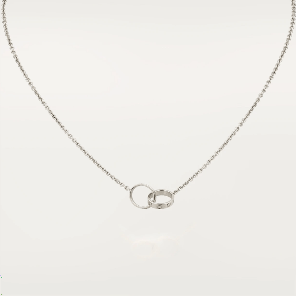 Elegant silver necklace with interlocking rings pendant, featuring a minimalist design. Perfect for fashion-forward jewelry lovers seeking timeless style.