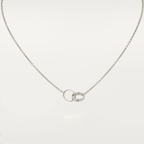 Elegant silver necklace with interlocking rings pendant, featuring a minimalist design. Perfect for fashion-forward jewelry lovers seeking timeless style.
