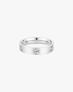 Silver band ring with three embedded round diamonds on a white background. Elegant jewelry, luxury accessory, diamond ring.