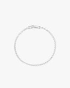 Elegant diamond tennis bracelet with a secure clasp, featuring sparkling round-cut diamonds set in a sleek, minimalist design. Perfect luxury jewelry.