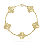 Gold floral bracelet with five clover-shaped charms on a delicate chain, featuring intricate detailing and a secure clasp. Elegant jewelry accessory.