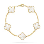 Gold chain bracelet with six white clover-shaped charms, featuring diamond accents. Elegant jewelry piece, luxury fashion accessory.