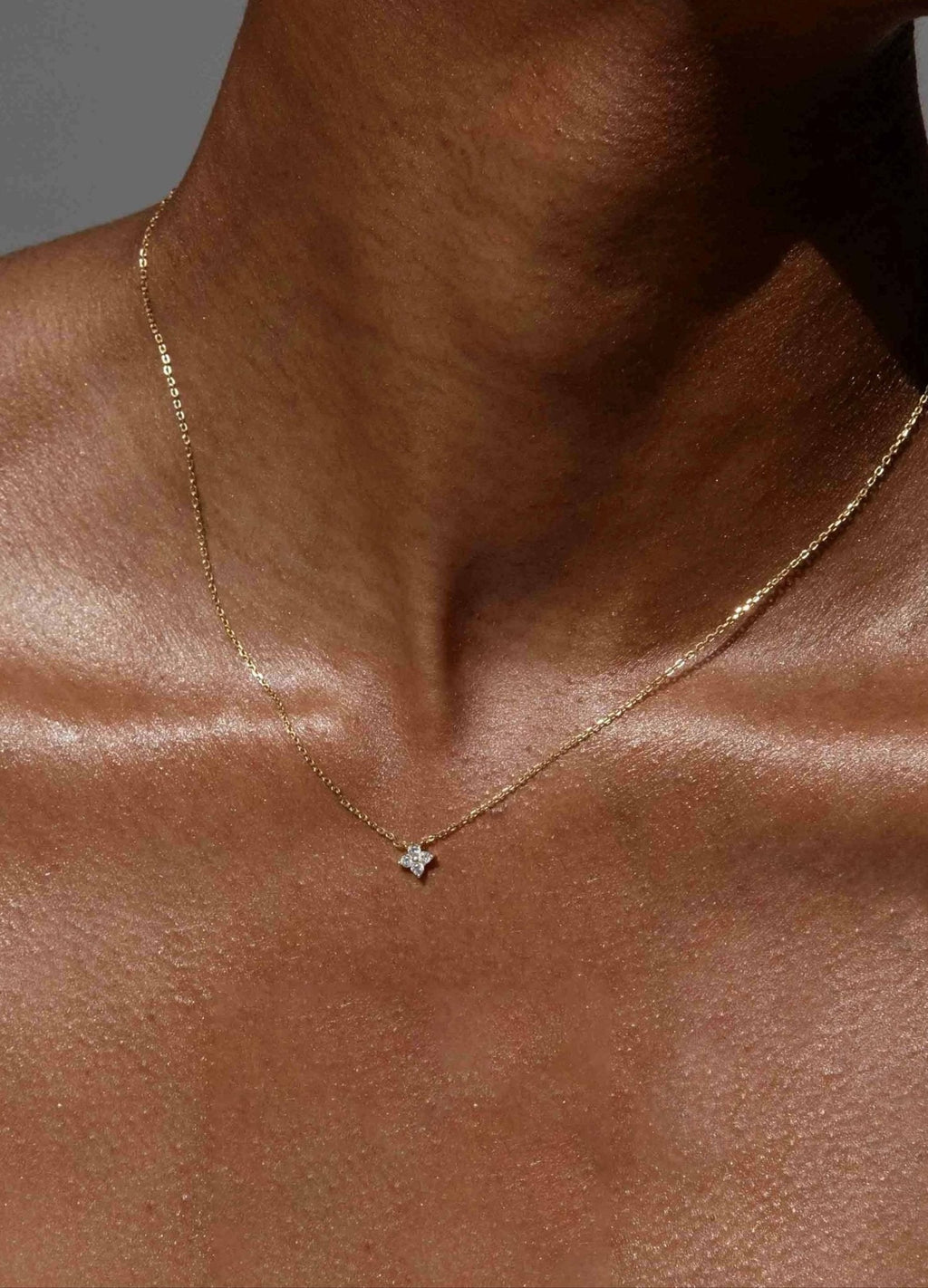 Delicate gold chain necklace with a small star pendant on a person's neck, minimalist jewelry, elegant accessory, fashion statement.