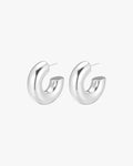 Silver hoop earrings on white background, minimalist design, polished finish, women's fashion jewelry, modern accessories, elegant style.