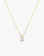 Gold chain necklace with a pear-shaped diamond pendant, minimalist jewelry design, elegant and timeless accessory for fashion and style enthusiasts.