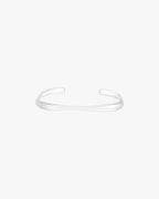 Minimalist silver cuff bracelet on white background, sleek and modern design, unisex jewelry accessory, perfect for fashion-forward style.