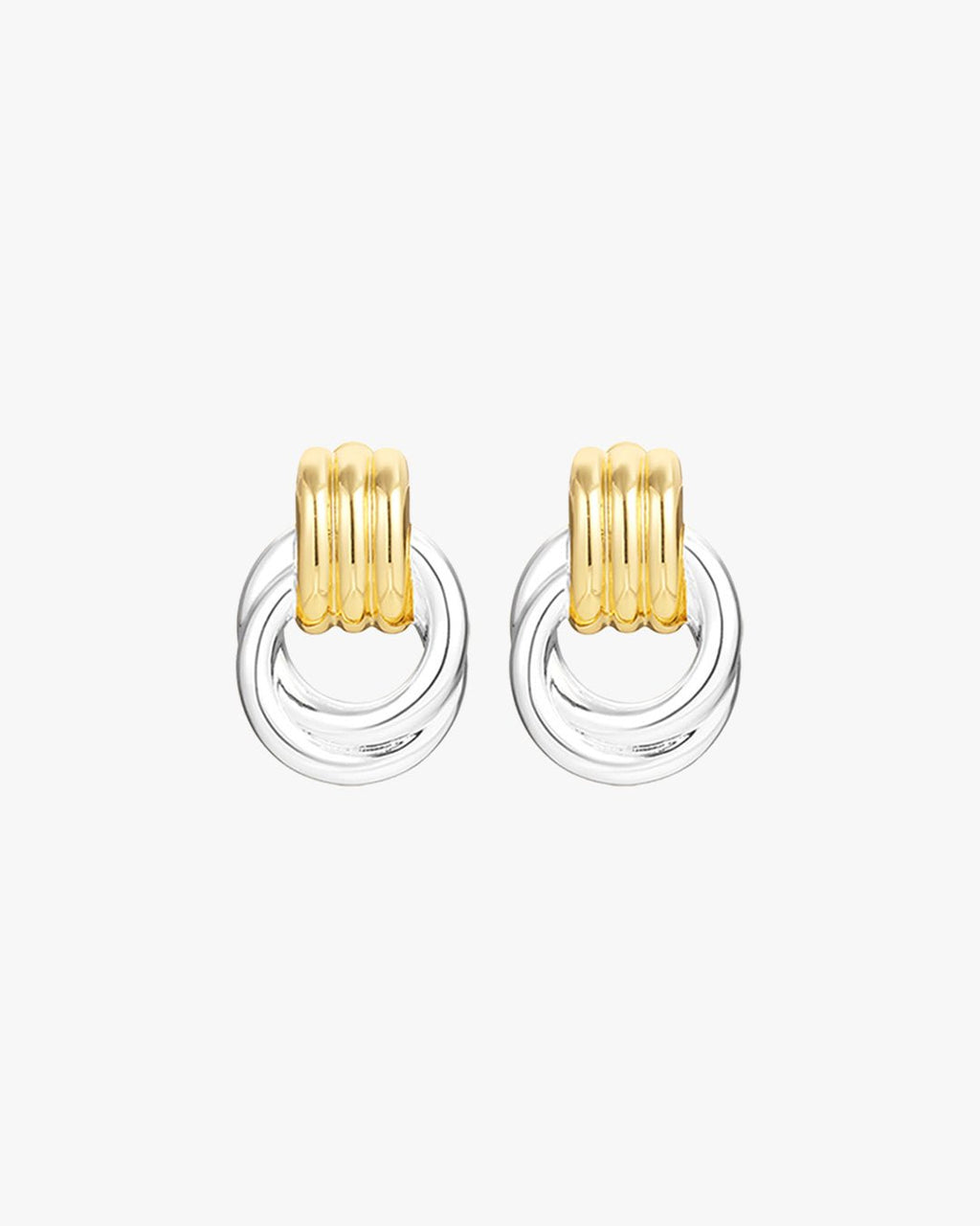 Gold and silver hoop earrings with ribbed design on white background. Fashionable mixed metal jewelry, modern accessory, elegant style.