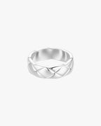 Silver braided ring on white background, showcasing elegant woven design. Perfect for jewelry enthusiasts seeking stylish, modern accessories.