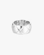 Silver quilted band ring with a polished finish, featuring a unique geometric pattern. Elegant jewelry accessory for fashion-forward style.
