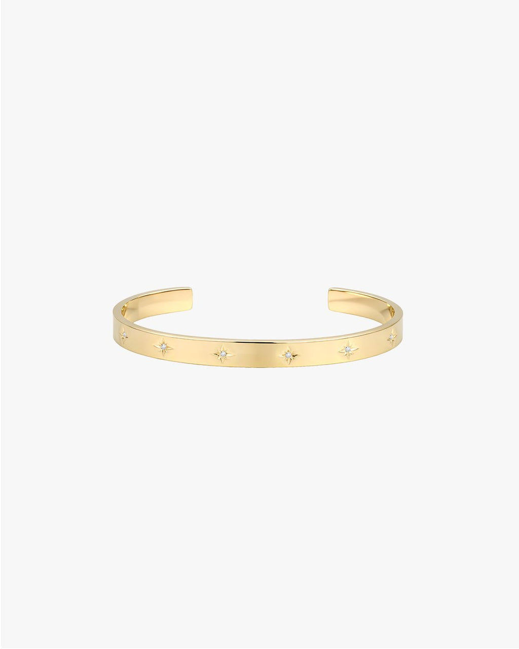 Gold cuff bracelet with star-shaped diamond accents on a white background. Elegant jewelry piece, perfect for fashion accessories and luxury style.