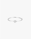 Minimalist silver ring with a single round diamond on a thin band, set against a white background. Elegant jewelry, perfect for engagements or gifts.
