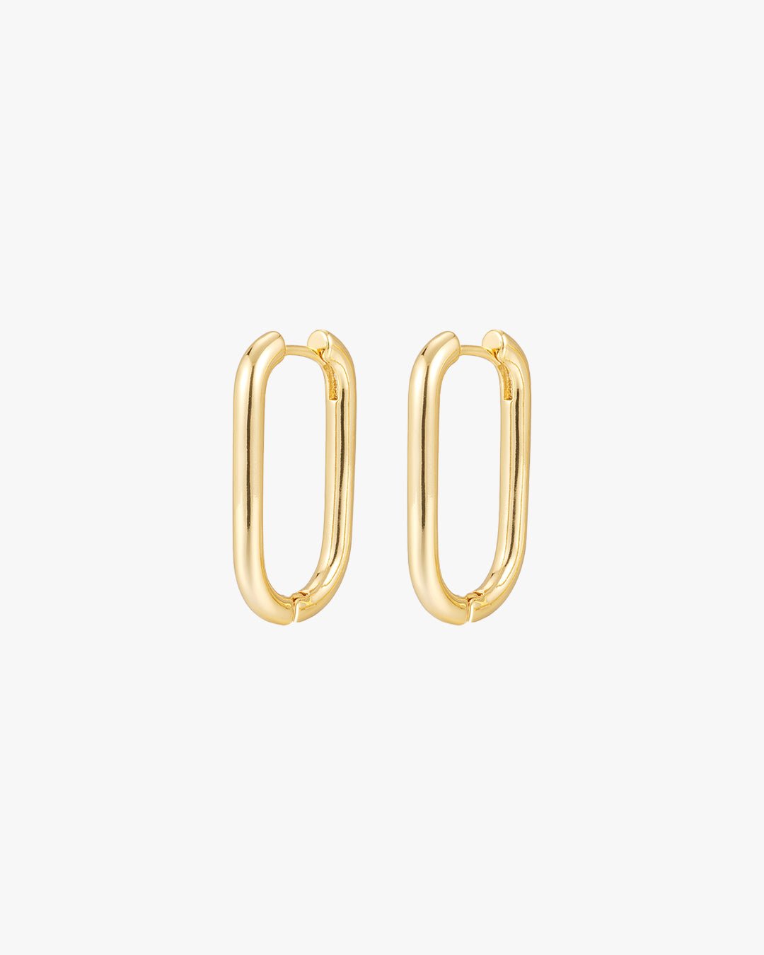 Gold oval hoop earrings on white background, minimalist jewelry, modern fashion accessories, elegant gold earrings for women, stylish hoop design.