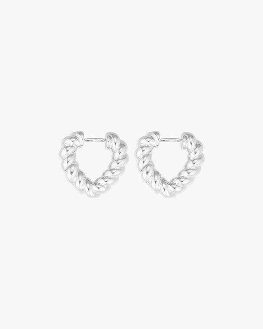 Silver twisted hoop earrings on a white background, showcasing elegant design and modern style. Perfect for fashion accessories and jewelry lovers.
