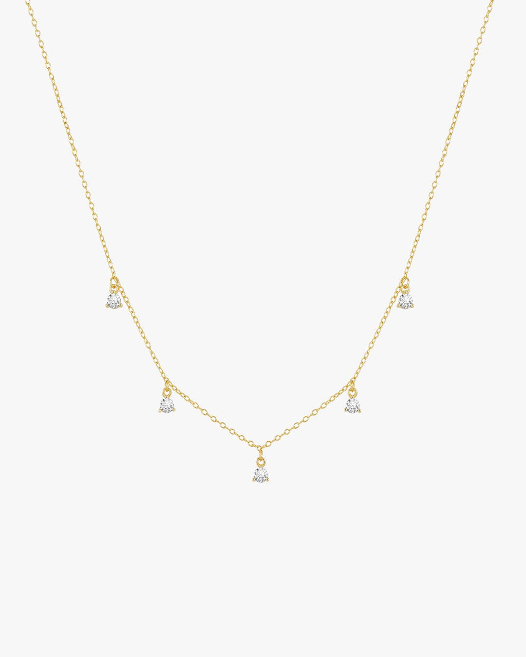 Gold necklace with five dangling diamond pendants on a delicate chain, elegant jewelry, minimalist design, perfect for special occasions.