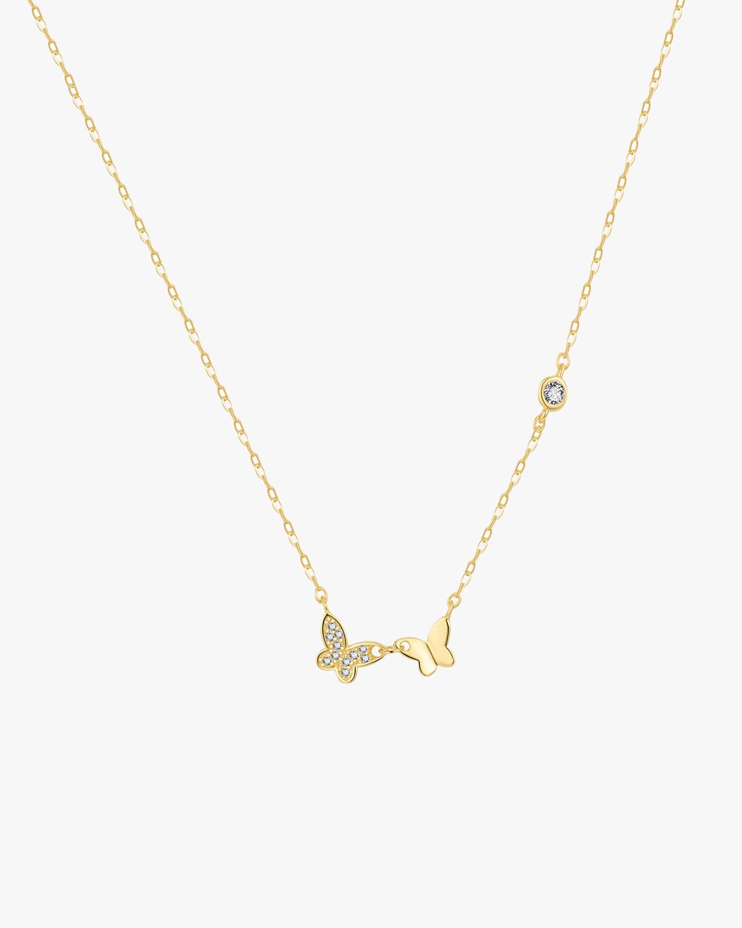 Gold butterfly necklace with diamond accents on a delicate chain, featuring a sparkling butterfly charm and a single diamond, elegant jewelry piece.