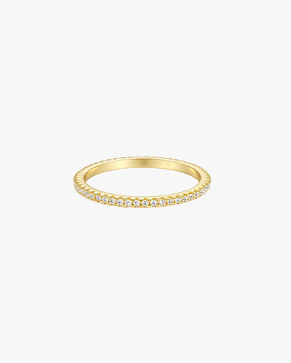 Gold diamond eternity band ring with round-cut diamonds, minimalist design, luxury jewelry, perfect for weddings or anniversaries, elegant style.